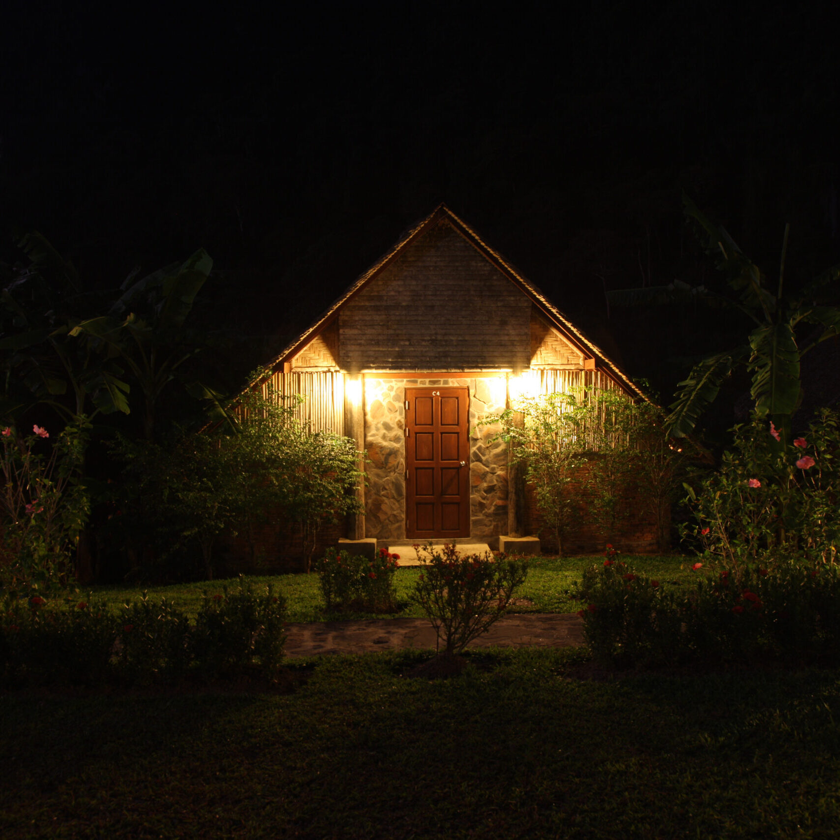 a photgraph of a country style cottage at night